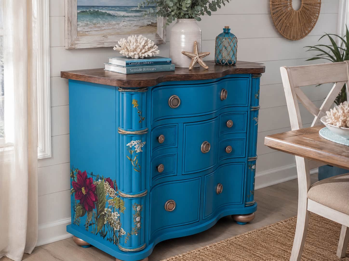 A serpentine dresser painted deep blue with a floral decor transfer