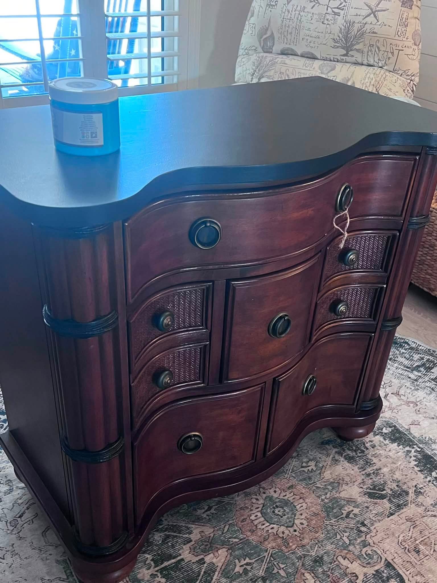 A dark cherry serpentine dresser before restoration